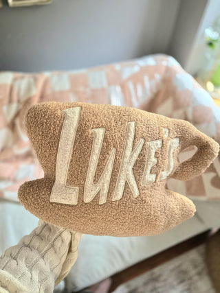 Plush toy with 'Luke's' embroidery on a checkered blanket