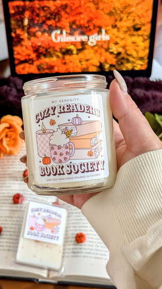 The Cozy Readers Book Society Candle is like snuggling up in your favorite blanket with a mug of pumpkin chai and a book you can’t put down!